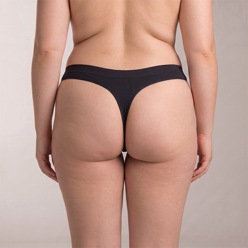Peaches thong in black, back view on model